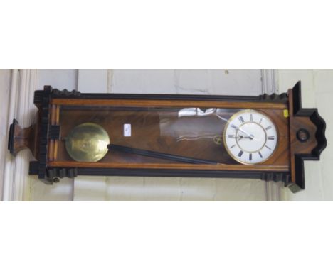 A 19th century-style mahogany and ebonised Viennese wall clock with shaped cornice, fluted supports, circular enamel dial wit