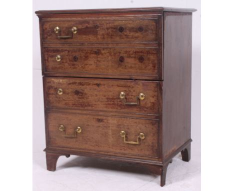 A 19th century Georgian mahogany commode chest raised on bracket feet with hinged metamorphic top and faux drawer front