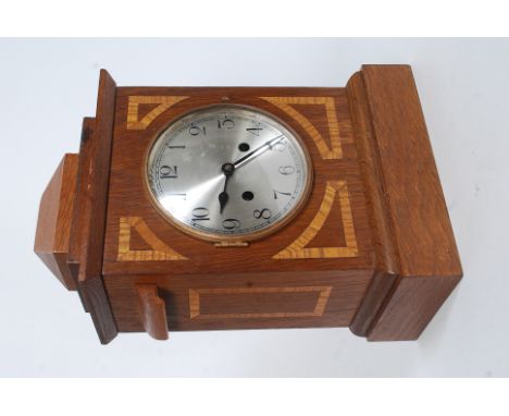 A mahogany inlaid cased eight day movement inlaid mantle clock striking on a coiled gong