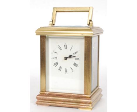 A good 20th century ACG large brass carriage clock, with white enamel dial, open viewing panes to all side and brass movement