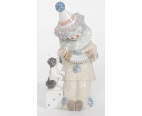 A Lladro figurine ' Pierrot with Concertin ' Model No 5279 impressed factory marks to base, blue stamp to base. Designed by: 