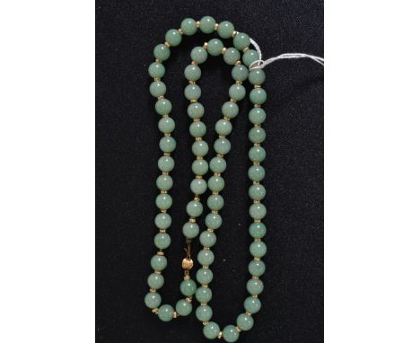 A malachite matching necklace and earrings set, along with a carved oriental jade necklace. 