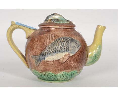 A 19th century Victorian ceramic Majolica tea pot embossed with fish possibly Perch
