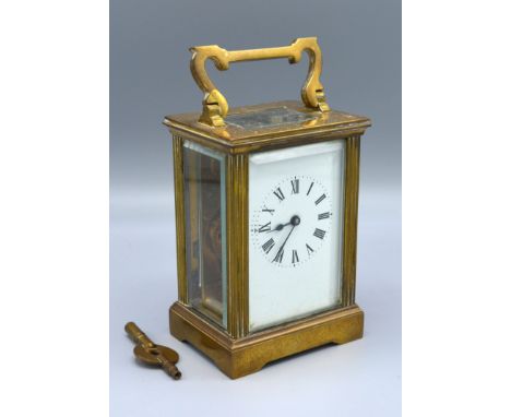 A Brass Cased Carriage Clock, the enamel dial with Roman numerals, 15 cms tall 