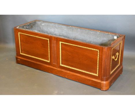 A French Mahogany and Gilt Metal Mounted Planter of rectangular form with a two panel front and brass side handles, 107 cms w