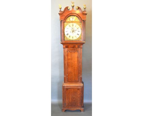 A George III Oak and Mahogany Long Case Clock, the swan neck pediment with brass finials above an arched door flanked by turn