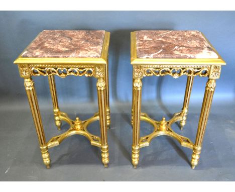 A Pair of French Style Gilded Lamp Tables of square form, the rouge marble tops above a carved frieze raised upon turned reed