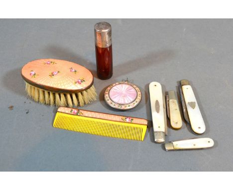 An Enamel Pendant Compact together with an enamel set comb and brush, four mother of pearl silver handled folding fruit knive