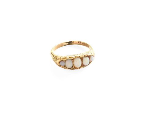 An 18 Carat Gold Opal Ring, three graduated oval cut opals flanked by round cut opals in yellow claw settings, to a plain pol