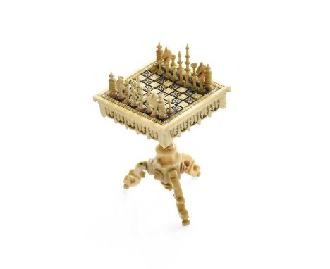 A Napoleonic Prisoner of War Bone Carving of a Chess Table, the square top set with miniature chess men, on a baluster pillar