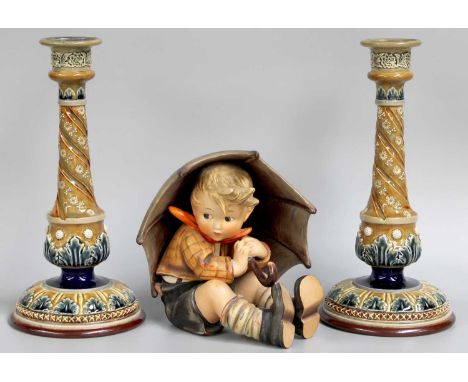 A Pair of Doulton Lambeth Table Candlesticks, 30cm high; together with a large Hummel figure of a girl with an umbrella (3)Al