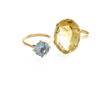 A Citrine Ring, the oval cut citrine, in a yellow claw setting, to a plain polished shank, finger size N; and A Synthetic Blu