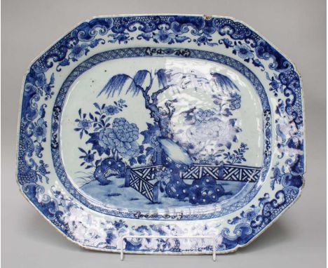 An 18th Century Chinese Export Octagonal Blue and White Meat Plate, landscape design within foliate scroll border, 46cm by 38