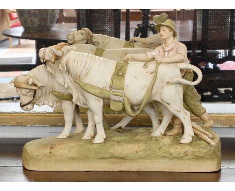 A Royal Dux Model of a Young Farmhand Harnessing a Pair of Oxen, post 1919, model number 2185, 44cm longIn good condition