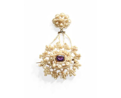 An Amethyst and Seed Pearl Brooch, the seed pearls laid upon a mother-of-pearl frame in a scrolling floral design, set centra