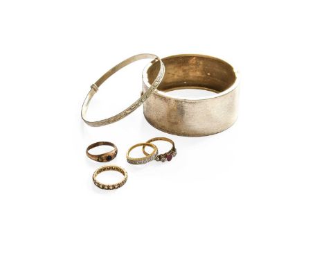 Four Rings, comprising of an 18 carat gold diamond half hoop ring, finger size K1/2; a ruby and diamond three stone ring stam