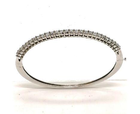 14ct marked white gold bangle set with 27 diamonds (approx 2.4mm diameter) - 6.5cm across x 5.5cm deep &amp; 13.1g total weig