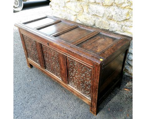Mid 17th century oak coffer with 3 panelled front with carved decoration. Four panelled top with original hinges and pegged j