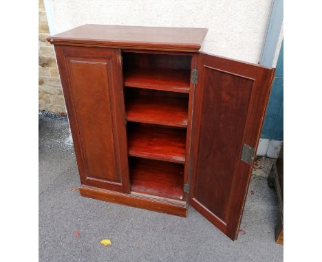 A Victorian Mahogany two panel door floor standing cupboard open to reveal four shelves within. 42.5cm deep x 76.5cm wide x 1