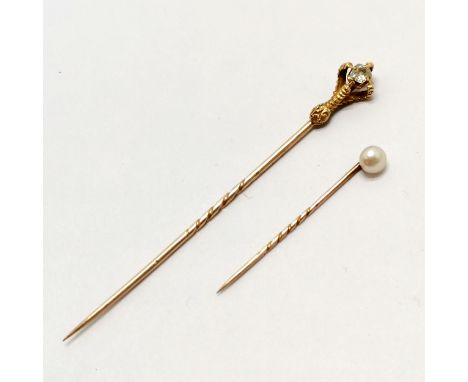 2 x unmarked gold stick pins - largest 8.5cm touch tests as 18ct gold and has a claw holding a diamond but will need bottom c