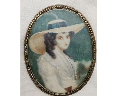 Portrait miniature of a young lady wearing a brimmed hat in an oval brass mount - 9cm x 7cm