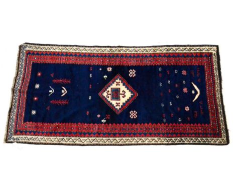 Kasak Rug Central Caucasus The deep indigo field with central diamond medallion surrounded by tribal motifs enclosed by ivory