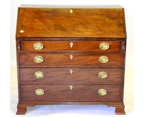 A George III Mahogany Bureau, with a fitted interior and four long drawers, on ogee bracket feet, 110cm by 53cm by 104cm 