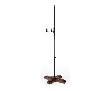 A Wrought Iron Adjustable Rush Light and Candle Holder, 17th/18th century, on an oak cross base, 105cm  