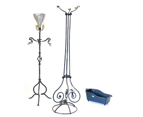 An Iron Uplighter, with metal shade, three brass light holders with scrolled arm brackets and a spiral turned support raised 