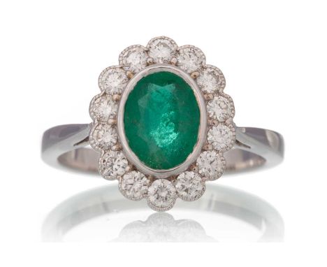 EMERALD AND DIAMOND CLUSTER RING, set with a central emerald of approximately 1.17 carats, within a halo of diamonds totallin