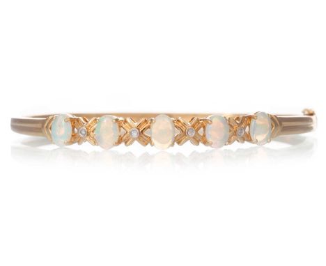 OPAL AND DIAMOND BANGLE, set with cabochon opals interspaced by small diamonds, in eighteen carat goldQty: 10.7g