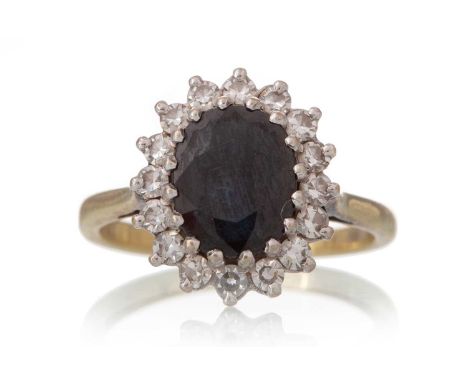 SAPPHIRE AND DIAMOND CLUSTER RING, set with an oval sapphire within a halo of diamonds, in eighteen carat goldQty: 4.5g