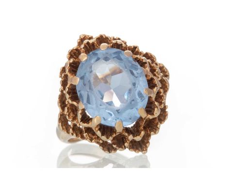 TOPAZ RING, the oval topaz set to a pierced mount, in nine carat gold, size HQty: 5.3g