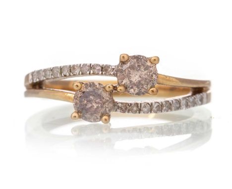 DIAMOND TWO STONE CROSSOVER RING, IN NINE CARAT GOLD the 'salt and pepper' stones totalling approximately 0.60 carats, on dia