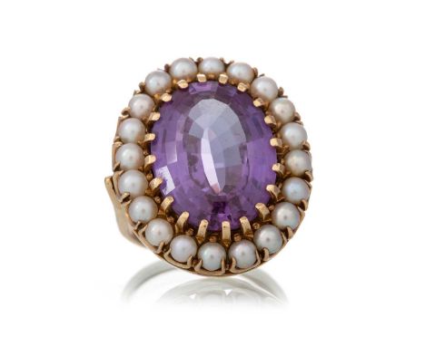 LARGE GEM SET AND SEED PEARL RING, set with a central blue/purple stone, within a halo of seed pearls, marked 10K, size QQty: