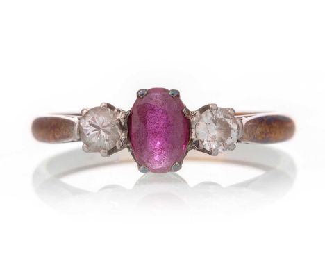 RUBY AND DIAMOND RING, the oval ruby flanked by two round brilliant cut diamonds, in eighteen carat gold, size NQty: 3g