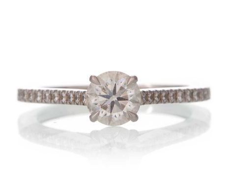 DIAMOND SOLITAIRE RING, the round brilliant cut stone of approximately 0.65 carats, on diamond shoulders, in platinum, size J