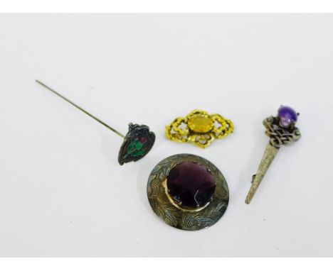 Scottish silver brooch, yellow metal and citrine brooch, pewter brooch and a silver and enamel thistle hat pin (4) 