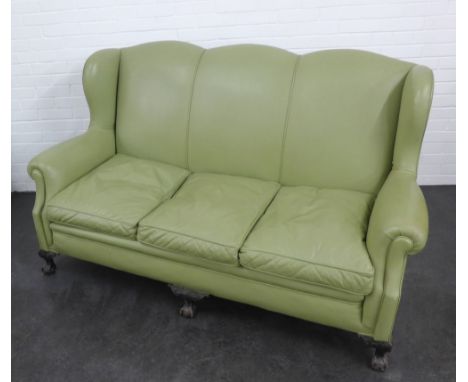 A light green leather upholstered sofa on carved claw and ball feet, 104 x 166cm
