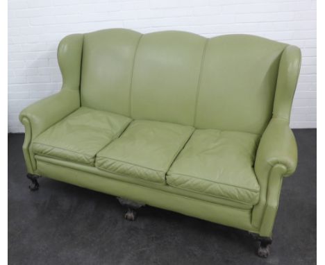 A light green leather upholstered sofa on carved claw and ball feet, 104 x 166cm