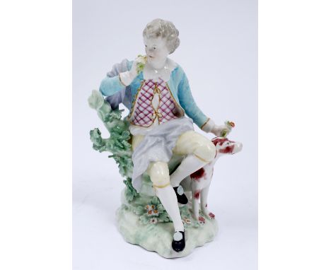 Derby porcelain figure with hound 19th Century seated on a tree trunk, wearing a turquoise jacket over a trellis pattern wais