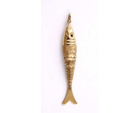 An 18K gold reticulated model of a fish with ruby eyes