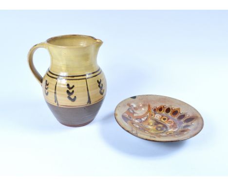 Winchcombe pottery jug 20.5cm and a Chelsea pottery plate decorated with a peacock, 20.5cm (2)