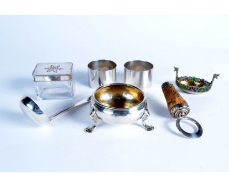 A small collection of silver and other wares including two napkin rings, a Georgian silver salt, a cork stopper, a sauce ladl