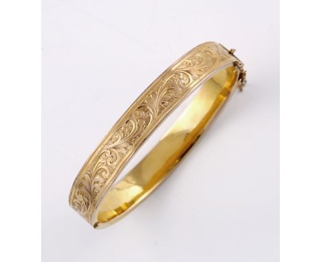 A 9ct gold bangle with engraved acanthus decoration, 13 grams