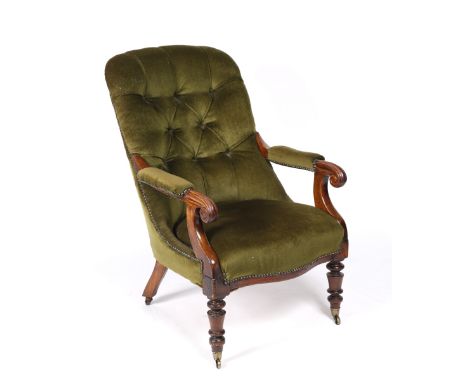 A Victorian mahogany armchair with green upholstered button back