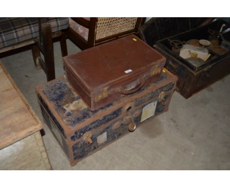 A metal bound trunk and a leather covered suitcase