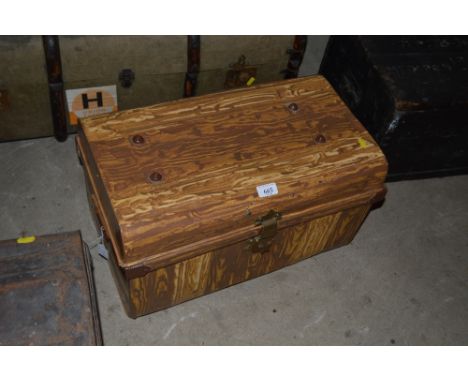 A grained effect japanned metal trunk with brass hasp