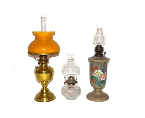A Victorian opaque and enamelled glass oil lamp, AF, a moulded glass oil lamp and brass oil lamp