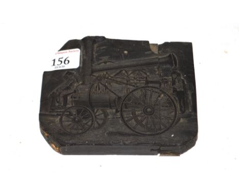 An ebonised printer's block depicting an early steam engine